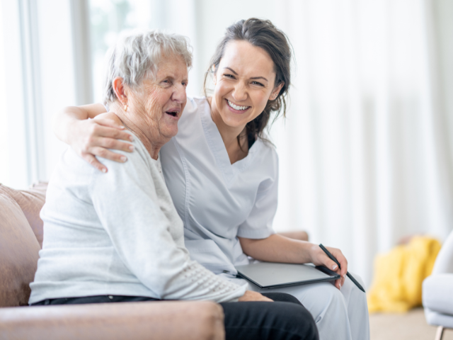 a nurse sitting with an old woman