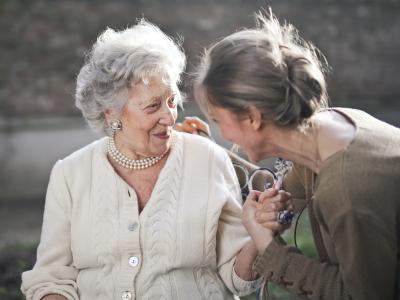 Two women in a garden at a care home 
