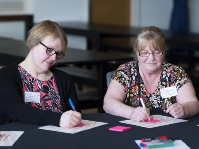 Two women taking part in an involvement activity