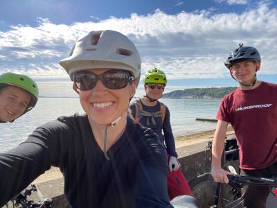 family cycling by the sea