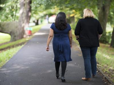 Image of two ladies walking in the park