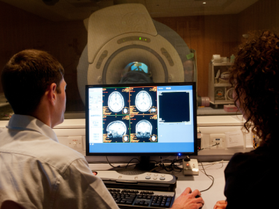 Brain scan with MRI scanner in the background