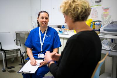 a research nurse talking to a patient