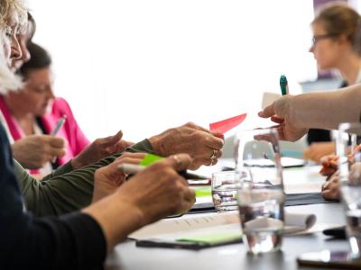 An image of researchers discussing public involvement at a table