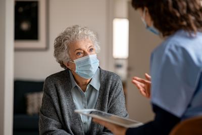 a nurse talking to an old woman