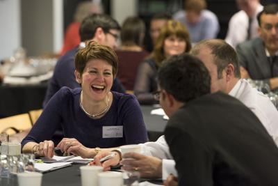 Woman laughing with colleagues at event
