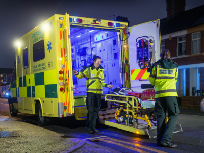 Paramedics putting a stretcher into an ambulance