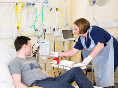 A nurse tending to a male patient. 