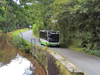 Bus driving through countryside.