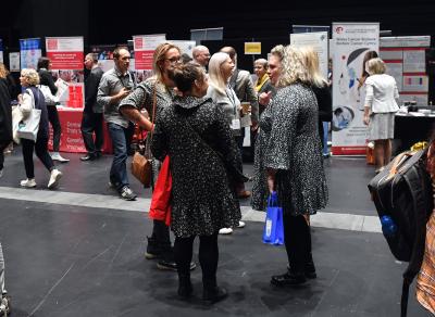 People at conference discussing research