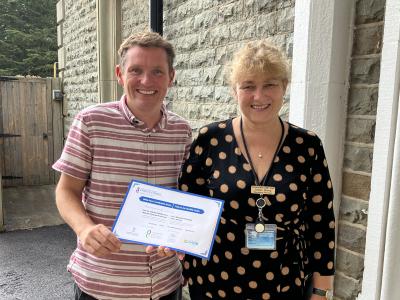 one_man_and_one_woman_hold_a_certificate