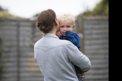 mother_with_back_turned_holds_child