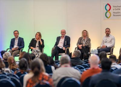 Group of 5 senior leaders in research sat on stage