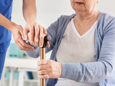 A nurse helping a patient stand up. 