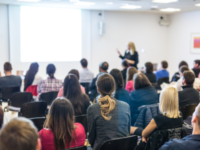 woman presenting at conference