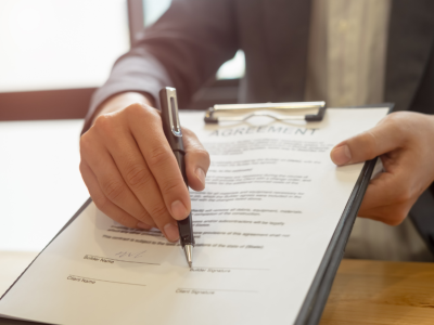 Signing a document. 