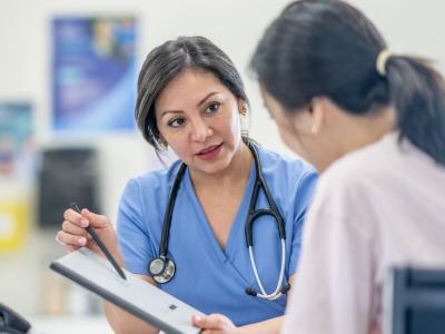a_female_clinician_talks_to_a_woman