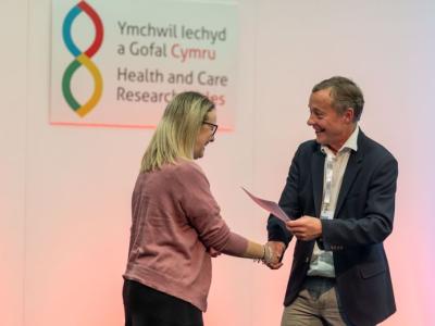 woman receiving award smiling